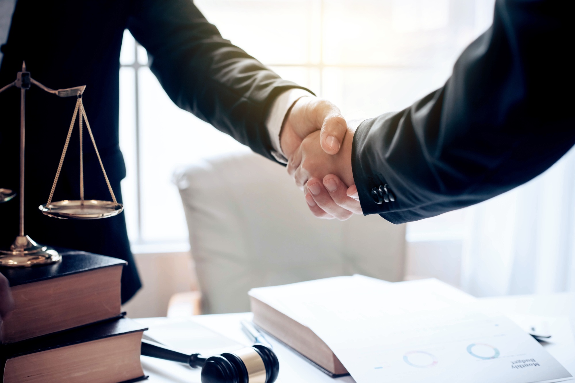 Businessman and lawyer shaking hands.
